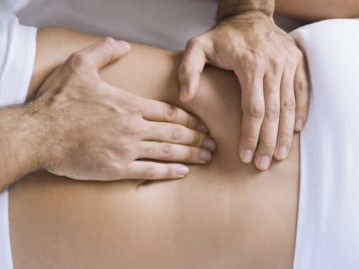 Chiropractor adjusting woman's spine